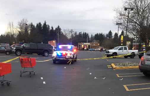 police car with police tape and evidence markers